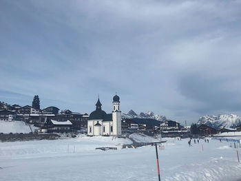 Snow covered buildings against sky