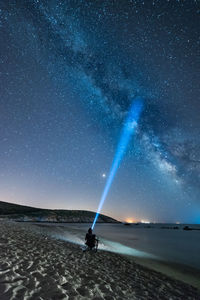 Scenic view of beach against sky at night