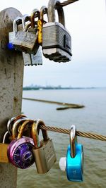 Close-up of padlocks hanging on metal