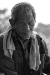 Close-up of senior man emitting smoke from nose