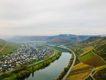 Aerial view of river amidst landscape against sky