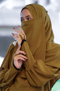 Close-up of muslim woman wearing mas, veil and abaya fashion clothes