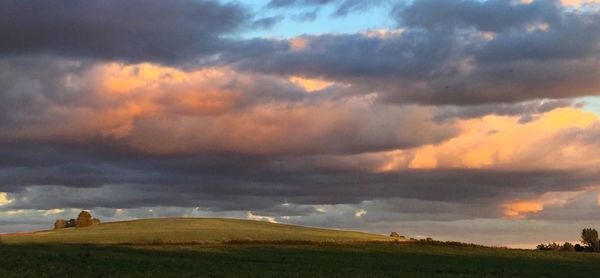 Scenic view of dramatic sky over agricultural field