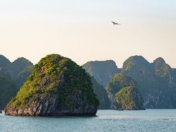 Scenic view of sea and mountains against sky