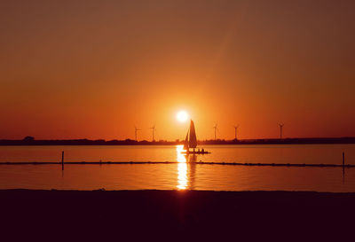 Scenic view of sea against orange sky