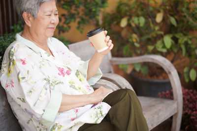 Portrait of young woman using mobile phone