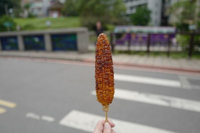 Close-up of hand holding ice cream cone