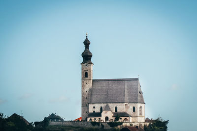  christian church on a raised rock as a dominant feature of christianity in the austrian lands