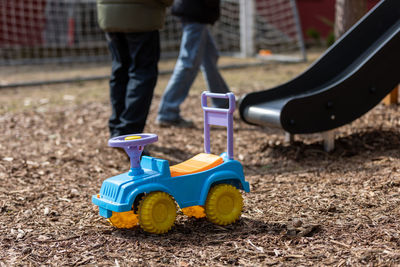 Low section of man holding toy on field