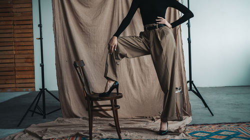 Low section of woman sitting on chair