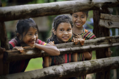 Cute siblings standing by railing