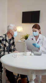 Doctor wearing mask examining patient