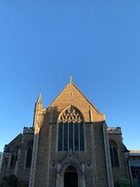 Low angle view of building against clear blue sky