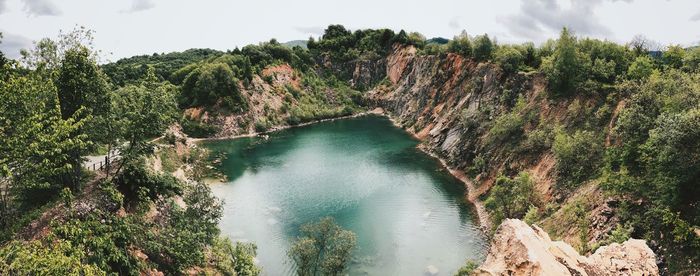 Panoramic view of river amidst trees against sky