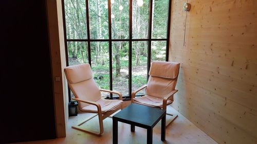 Chairs and table by window at home