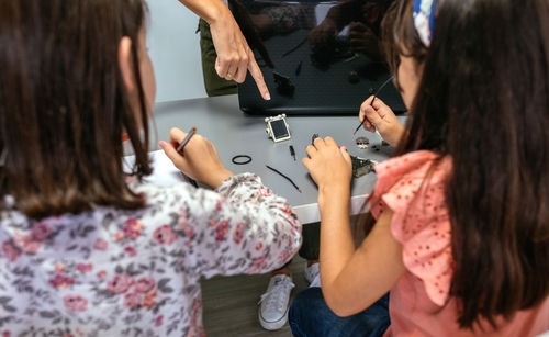 Teacher showing solar panel to her students in a robotics class