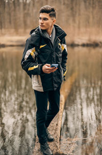Full length portrait of man standing in water