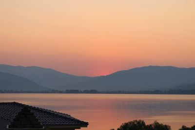 Scenic view of lake against romantic sky at sunset