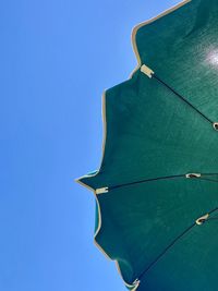 Low angle view of leaf against blue background