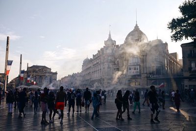 Group of people walking in front of buildings