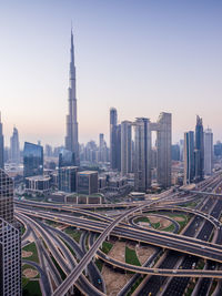 Aerial view of buildings in city against clear sky