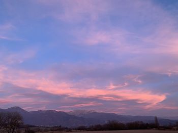 Scenic view of silhouette mountains against sky at sunset