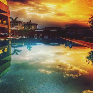 Scenic view of dramatic sky over city during sunset