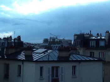 Buildings against cloudy sky