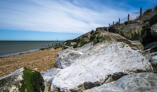 Rocks on beach against sky