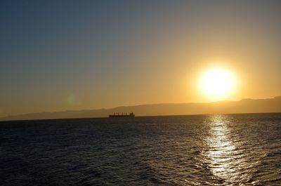 Scenic view of sea against clear sky during sunset