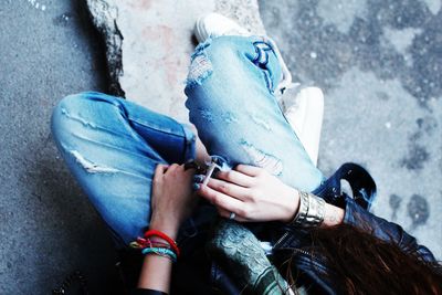 Close-up of woman sitting on rock