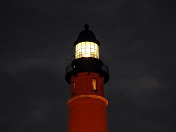 Low angle view of lighthouse against sky at night