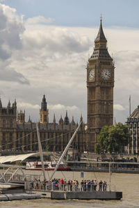 View of clock tower at riverbank