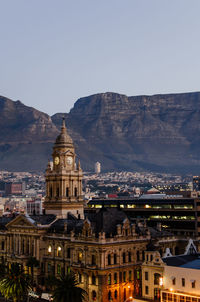 Buildings in city against clear sky