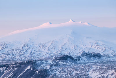 Aerial view of snowcapped mountains against sky