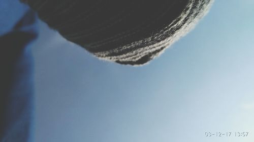 Low angle view of snow against clear blue sky