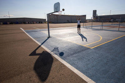 Full length of man playing basketball