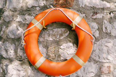 High angle view of orange container on rock