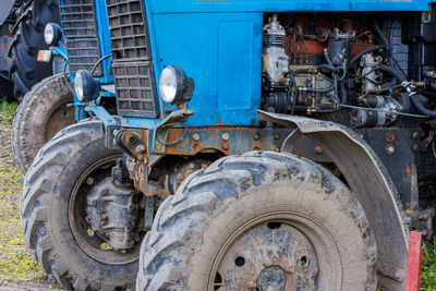 Blue belarussian tractors, wheels and opened diesel engine compartments view