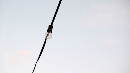 Low angle view of telephone pole against clear sky