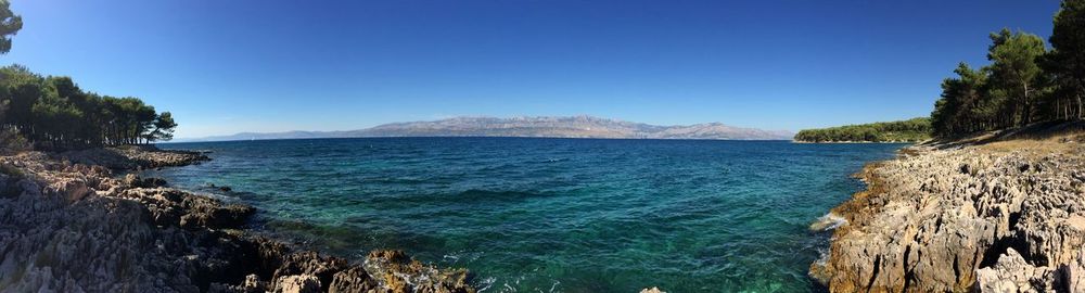 Scenic view of sea against clear blue sky