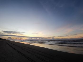 Scenic view of beach against sky during sunset