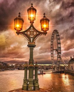 Illuminated street light in city at night