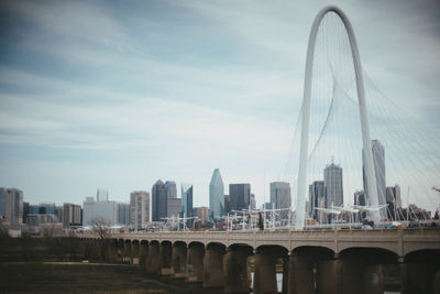 View of bridge and buildings against sky