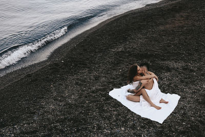 High angle view of woman lying on beach