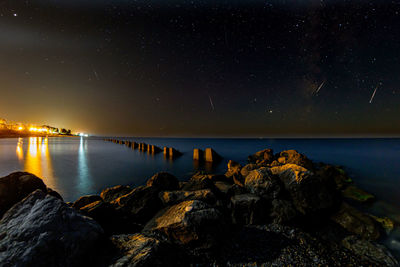 Scenic view of sea against sky at night