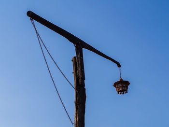 Low angle view of street light against clear blue sky