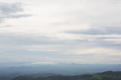 Scenic view of mountains against cloudy sky