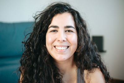 Close-up portrait of young woman at home