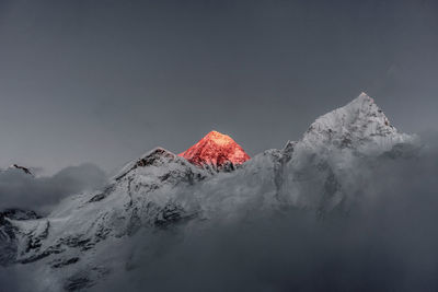 Low angle view of snow capped mountain against sky